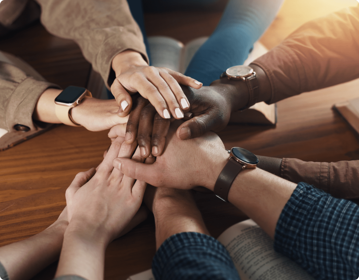 Hands united in a teamwork gesture.